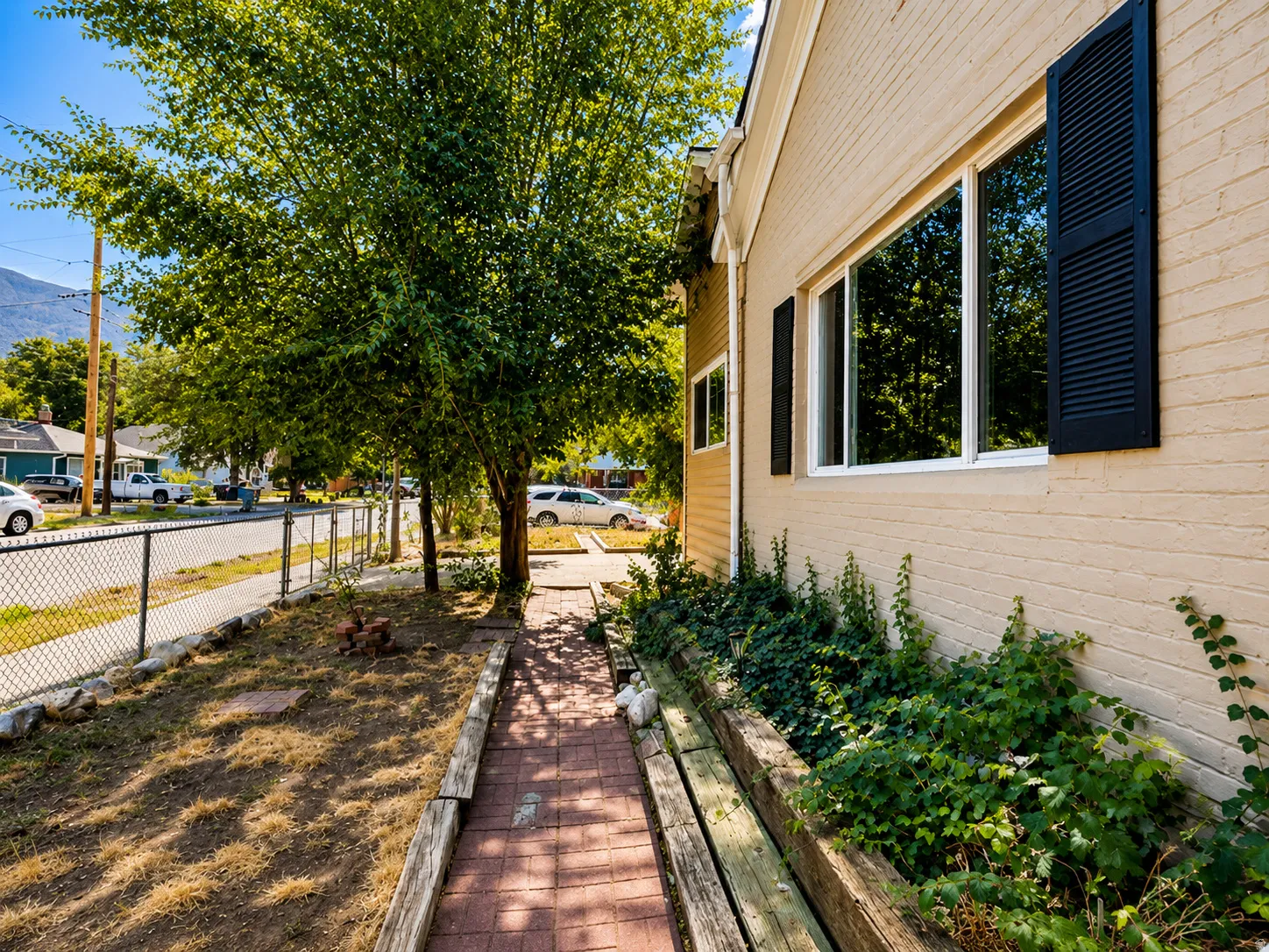 Brick exterior with a multi-pane window and louvered shutters