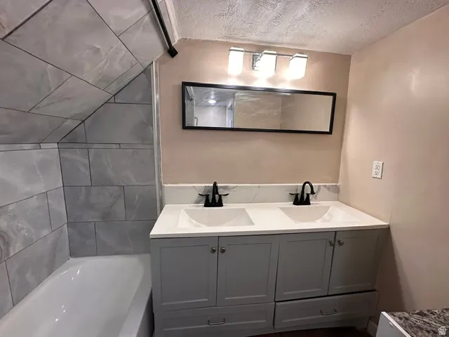 Double vanity with matte black faucets, integrated sinks, and lower cabinetry