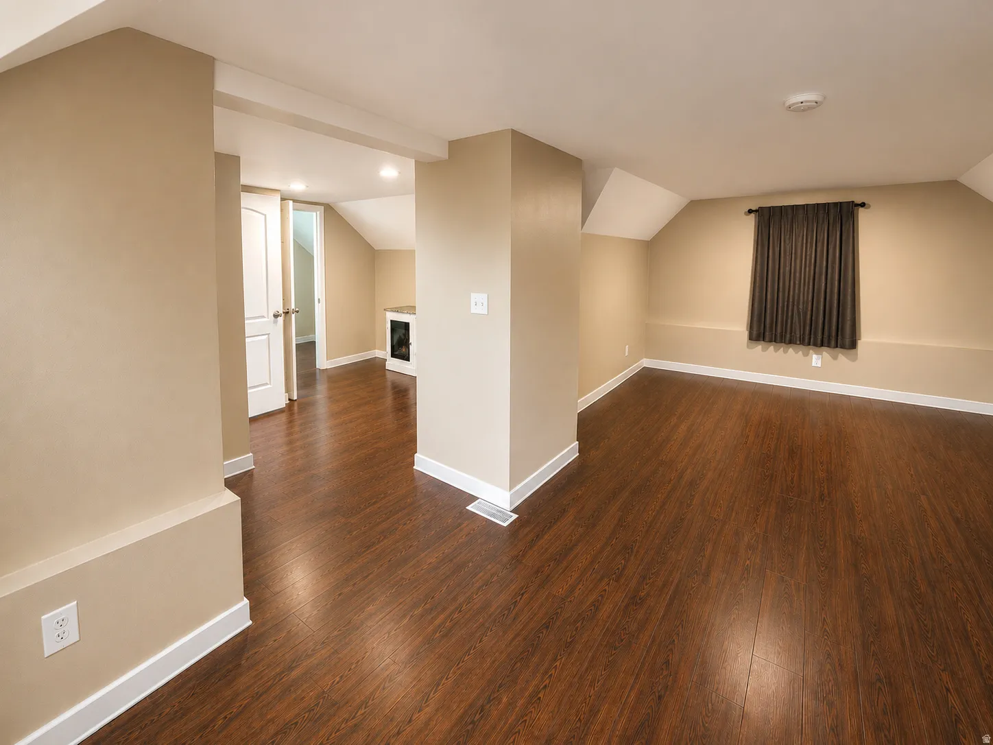 Wood-finish flooring throughout, neutral wall paint, white trim, and recessed lighting