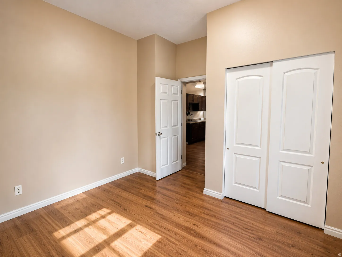 Wood-finish flooring with neutral wall tones and white trim