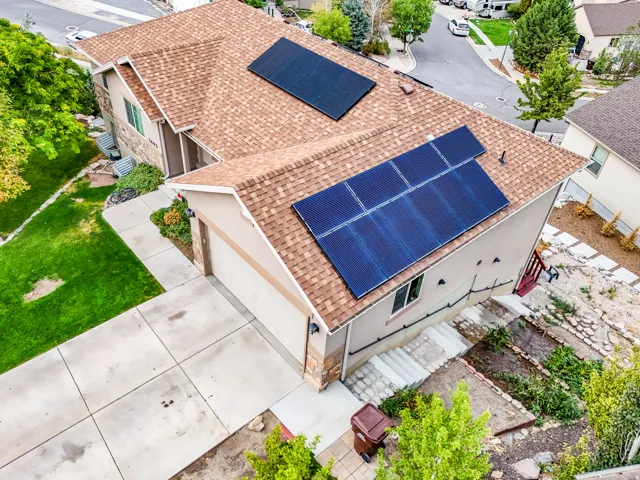 Property with solar panel installation, attached garage, and concrete driveway