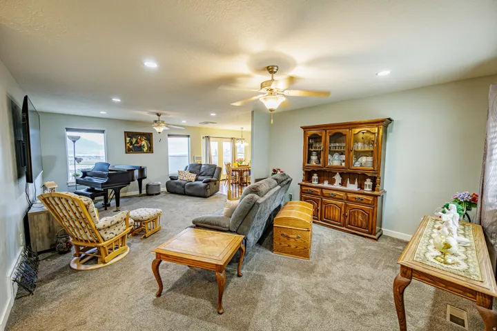 Recessed lighting, ceiling fans, multiple windows, and light-colored walls