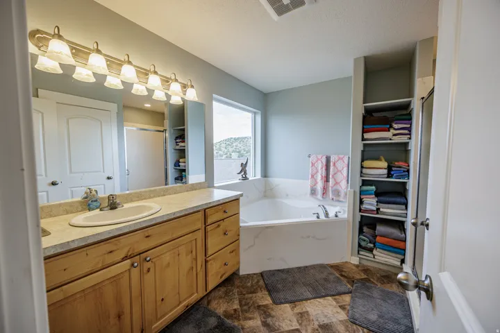 Wood-finish vanity with an integrated sink and light-toned countertop