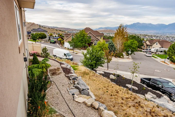 Terraced landscaping featuring rock retaining walls and planted vegetation
