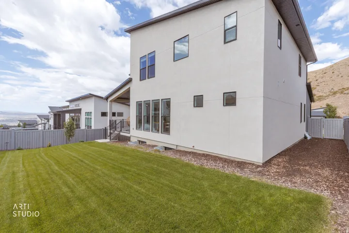 Modern architecture featuring a smooth stucco exterior and dark-framed windows