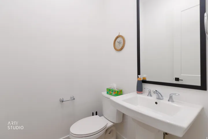 White pedestal sink with chrome faucet