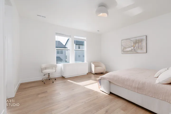 Recessed lighting, wood-finish flooring, white walls, and a contemporary flush-mount ceiling light