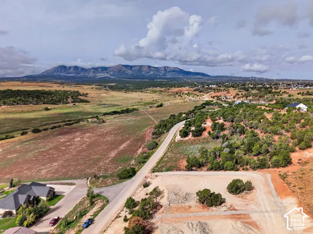 Expansive rural landscape featuring distant mountains and scattered residential development