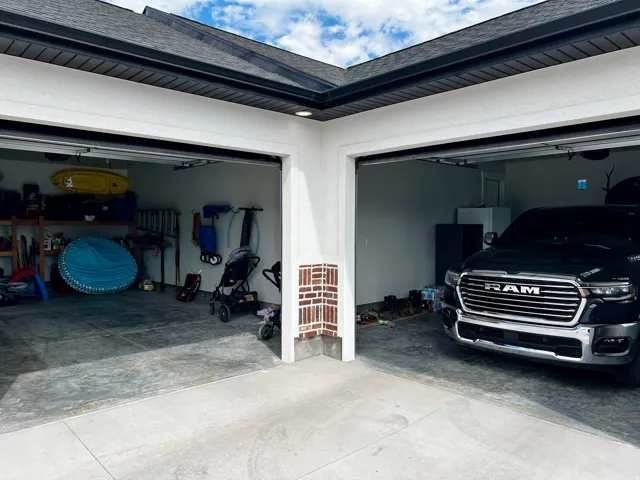 Two-car garage with individual bay doors and concrete flooring