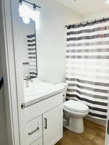 Bathroom featuring a white vanity with brushed nickel hardware, an undermount sink, and a single-handle faucet
