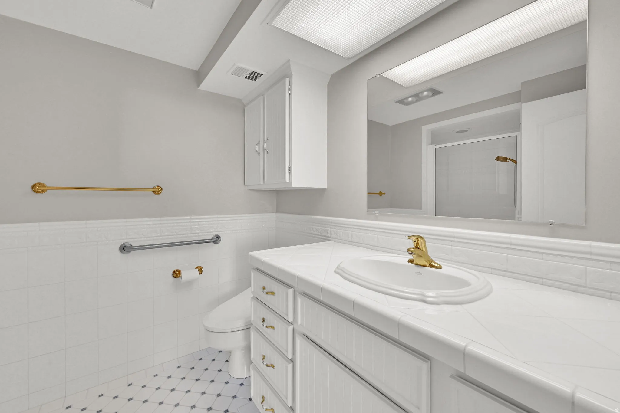 White tile flooring with decorative accents