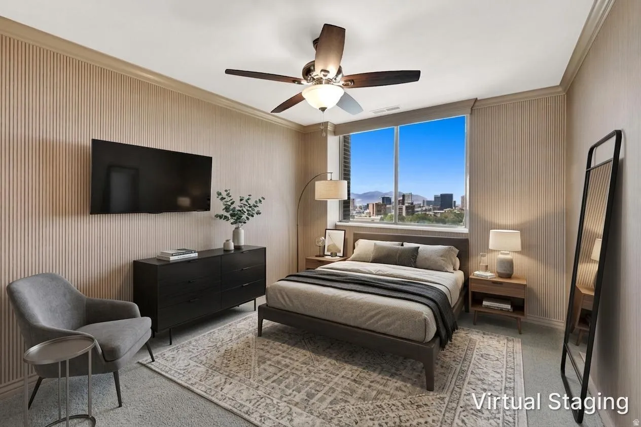 Expansive window with city and mountain scenery, ceiling fan with integrated lighting, textured wall finishes, and crown molding