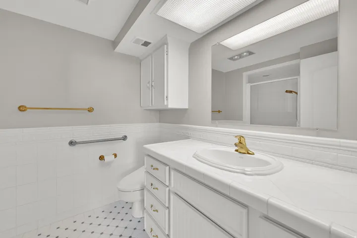 White tile flooring with decorative accents