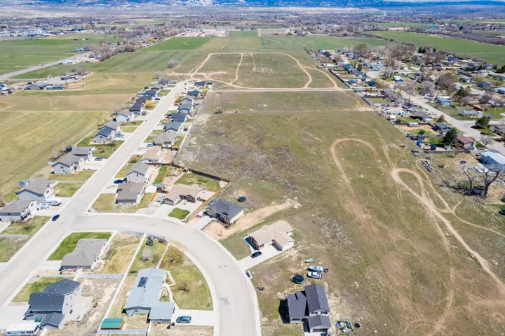 Expansive undeveloped land parcels with established residential areas bordering