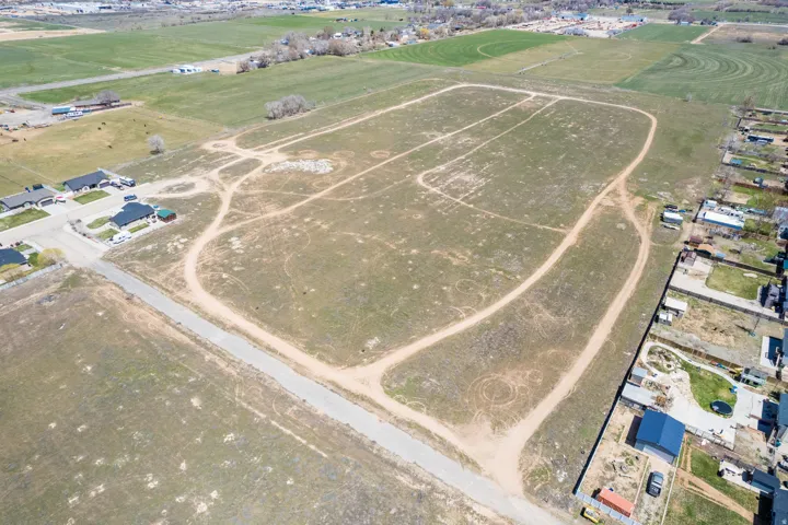 Expansive undeveloped land featuring diverse terrain and established perimeter roads