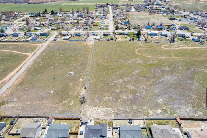 Expansive undeveloped land parcel with surrounding residential properties