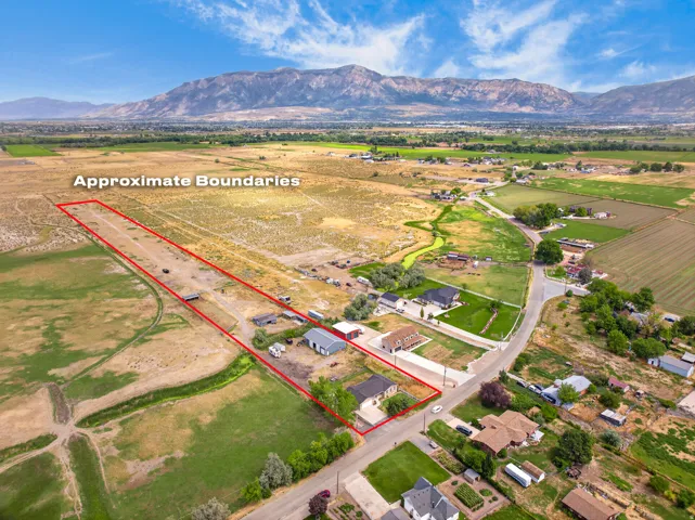 Expansive land parcel with surrounding agricultural fields and distant mountain ranges