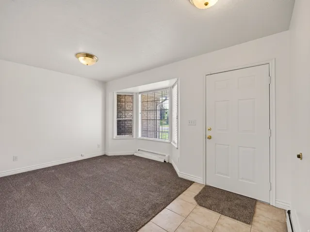 Entryway with panel door, tiled flooring, and flush mount lighting