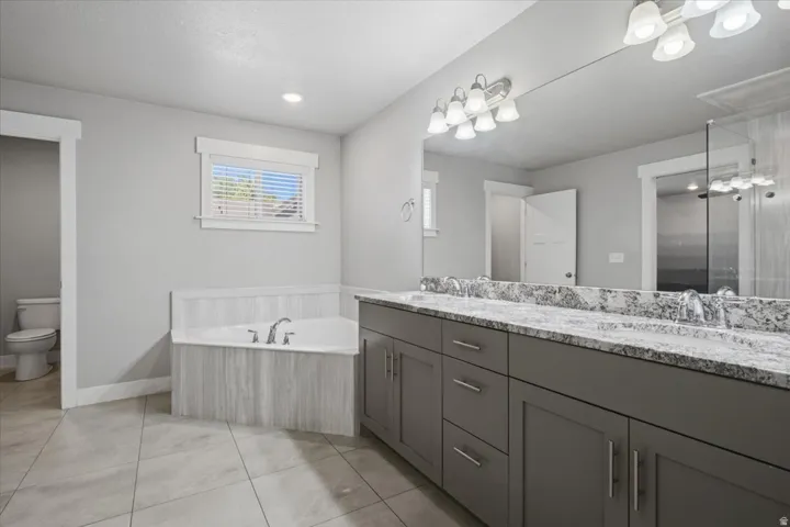 Dual vanity with stone-finish countertop, undermount sinks, and matte silver fixtures