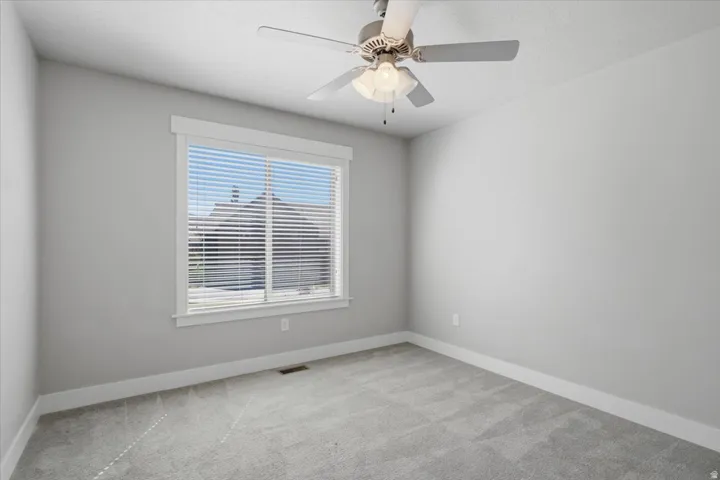 Recessed lighting with a ceiling fan, neutral wall paint, white trim, and light-toned carpeting
