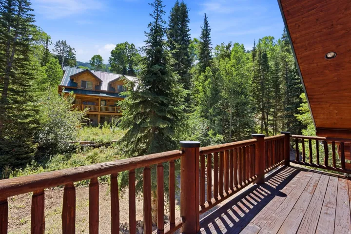 Wood-finish deck with a log railing system and visible wood grain