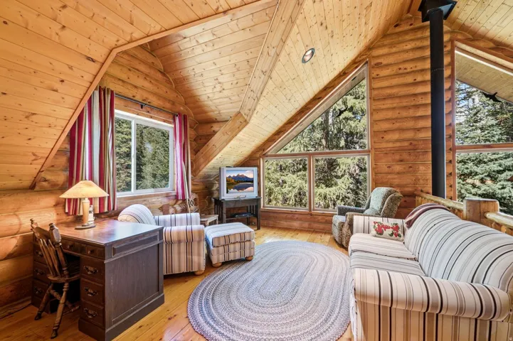 Wood-paneled ceilings, exposed log walls, and wood-finish flooring