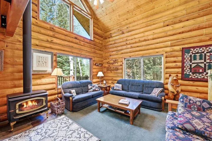 Wood-paneled walls and a high vaulted ceiling with exposed beams