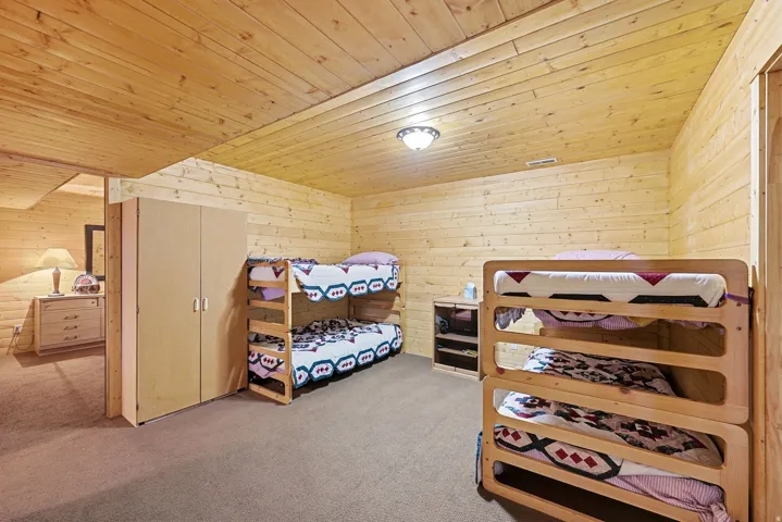 Wood-paneled walls and ceiling with recessed lighting