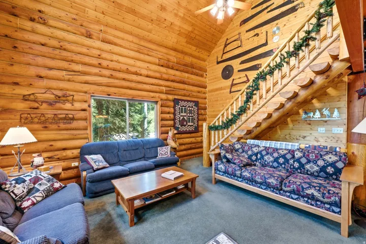 Wood-paneled walls and ceiling featuring a prominent wooden staircase with a matching railing