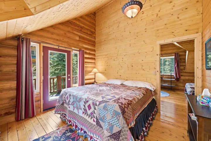 Wood-paneled walls and ceiling, wood-finish flooring, and a glass-paneled exterior door