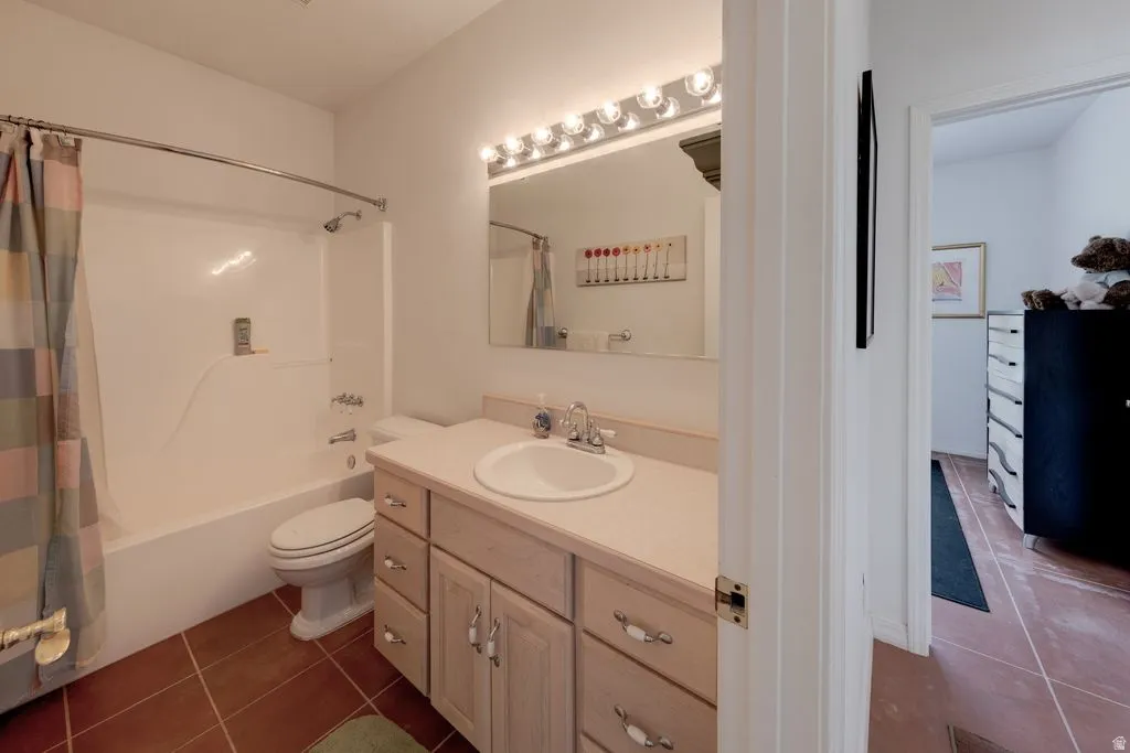 Bathroom featuring a vanity with a countertop, integrated sink, and wood-finish cabinetry