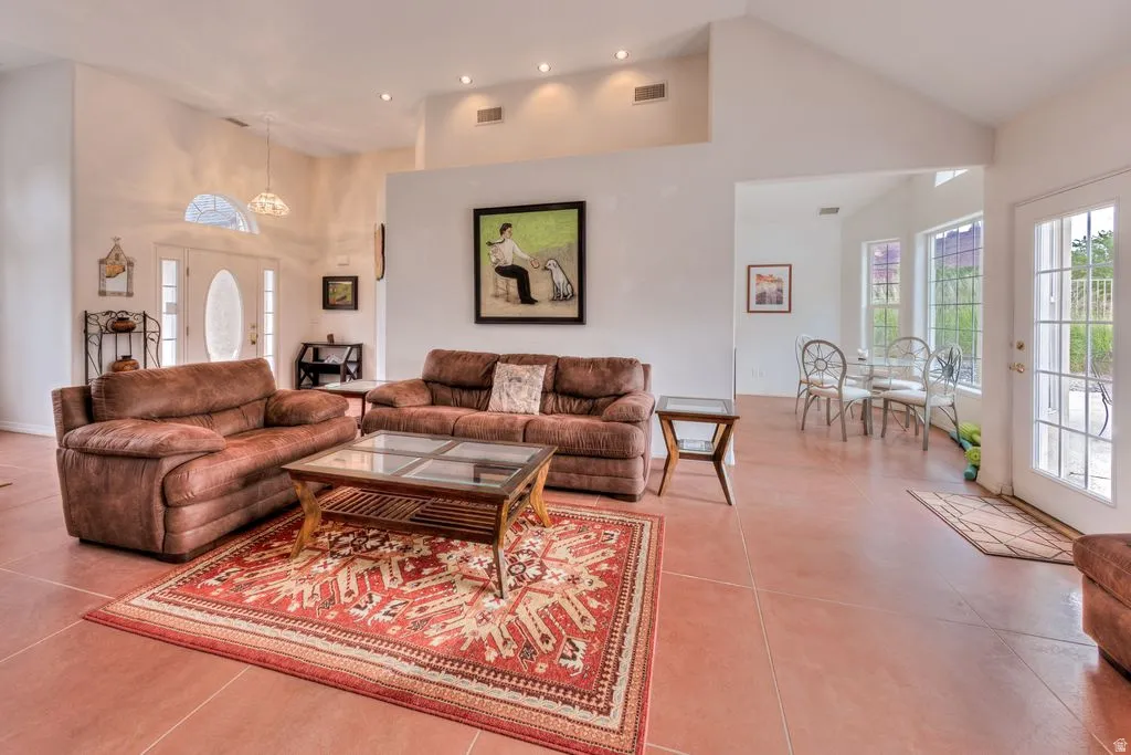 Vaulted ceilings, recessed lighting, and tile flooring