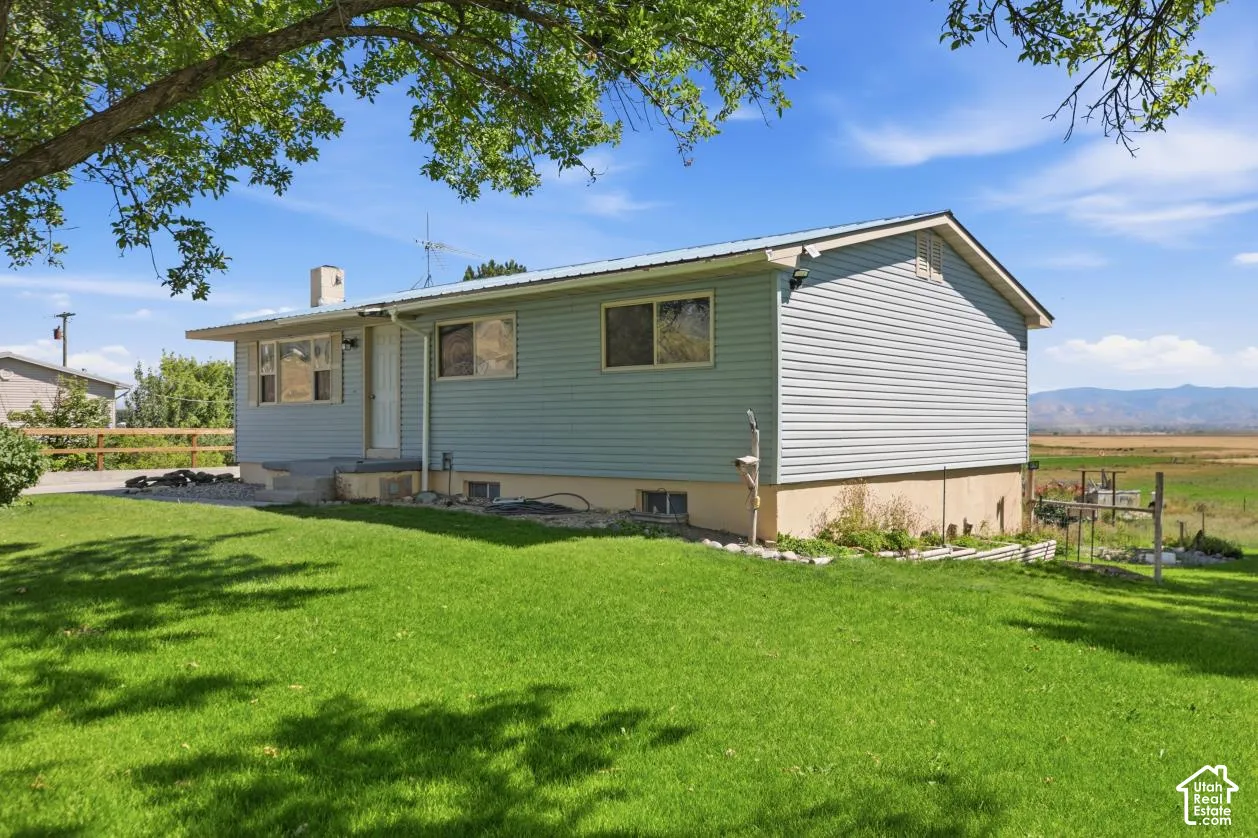 Siding exterior with a light blue finish, contrasting white trim, and a metal roof
