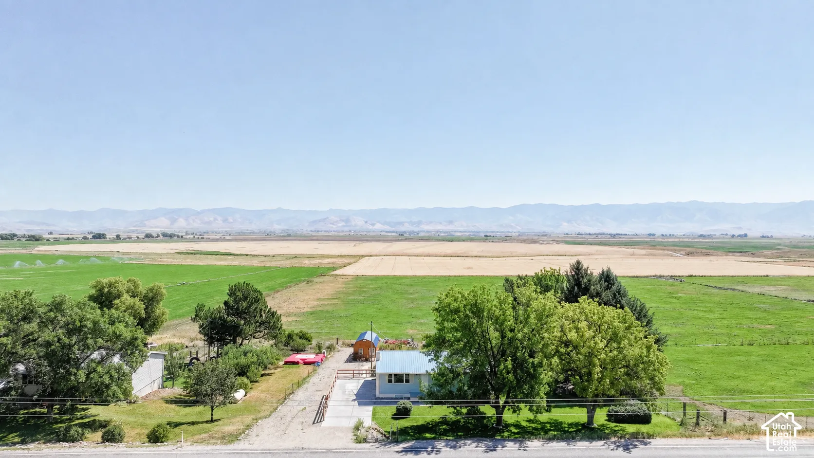 Expansive agricultural surroundings with distant mountains
