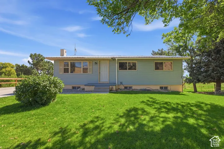 Light blue siding exterior with a metal roof