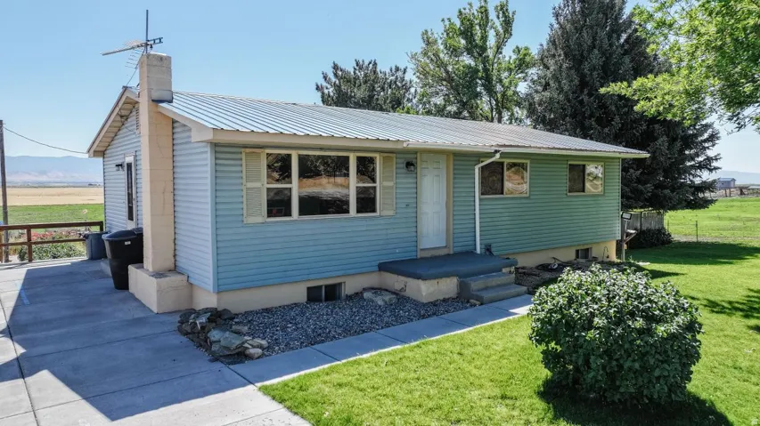 Light blue siding exterior with a metal roof