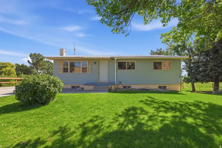 Light blue siding exterior with a metal roof
