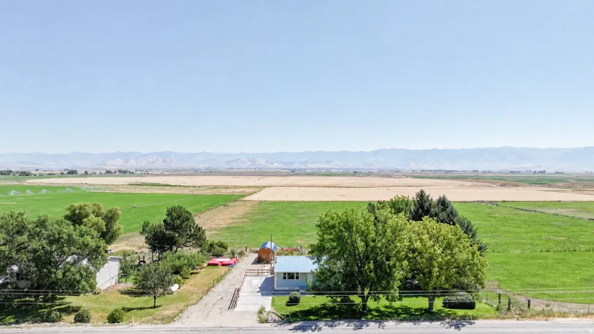 Expansive agricultural surroundings with distant mountains