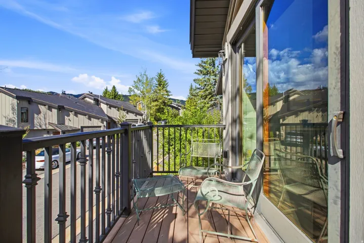 Private balcony with wood-finish decking and dark-finish railings