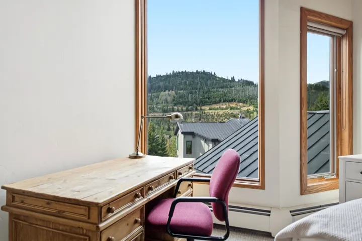 Wood-trimmed windows with scenic mountain backdrop