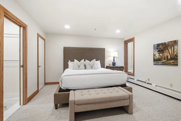 Recessed lighting, wood-trim doorway, wood-trim window, carpeted flooring, and white wall finishes