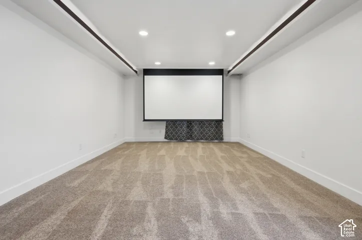 Recessed lighting, integrated projector screen, and contrasting ceiling beams