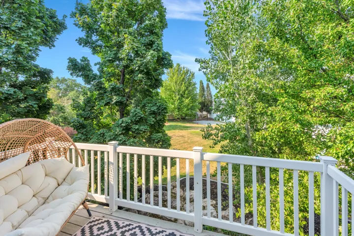 Outdoor deck featuring white railings and wood-finish flooring