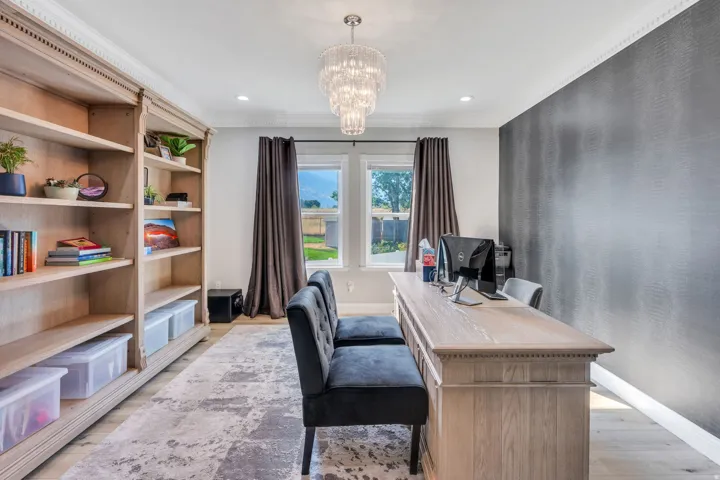 Integrated wood-finish shelving, wood-finish flooring, and a crystal chandelier