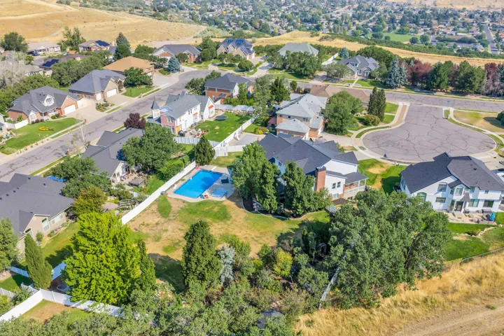 Residential property featuring an in-ground swimming pool, expansive grounds, and a cul-de-sac