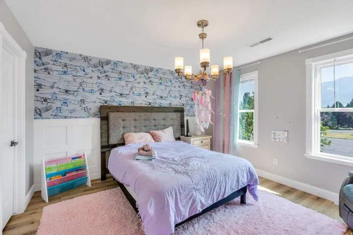 Hardwood-style flooring with light gray walls and white trim