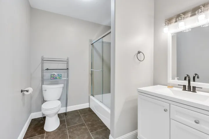Tub and shower combination with glass enclosure