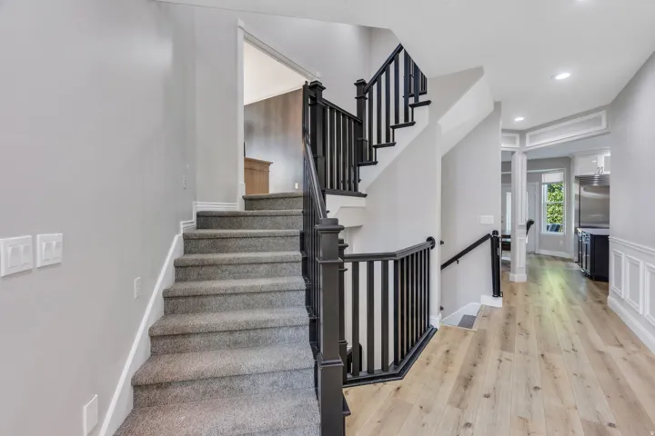 Staircase featuring dark wood newel posts and spindles