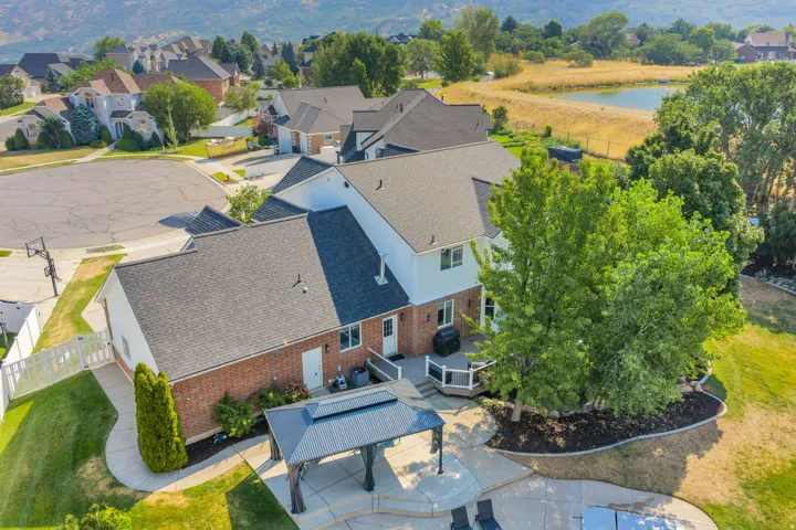 Brick and siding exterior with a multi-level deck and stone patio