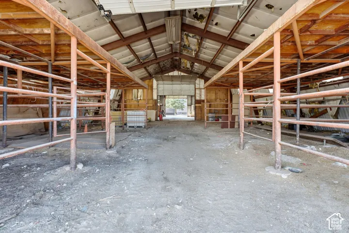Metal-framed interior with a gravel floor and overhead metal roofing